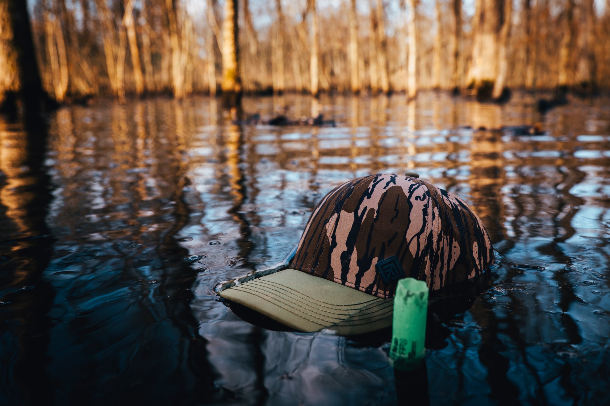 Camo Terreno hat floating in swamp