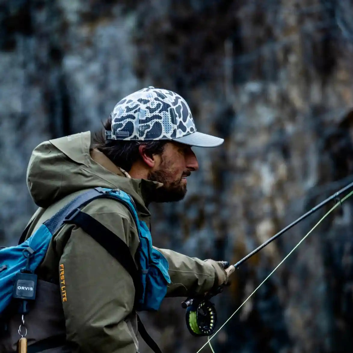 Man fishing in a natural setting with a blurred background