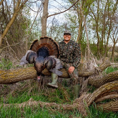 Hunter in hat with harvested turkey
