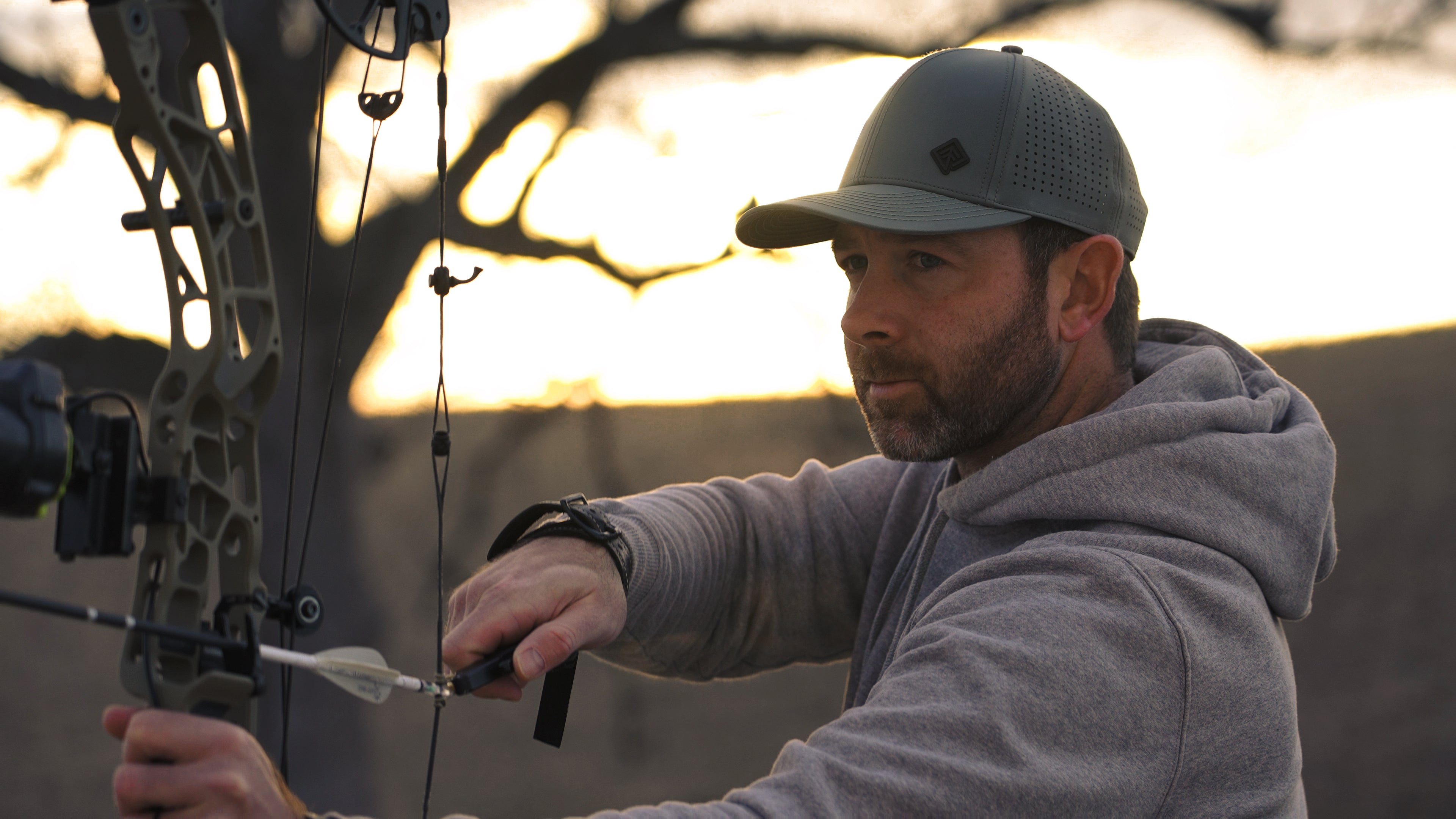 Archer in olive Terreno hat at sunset
