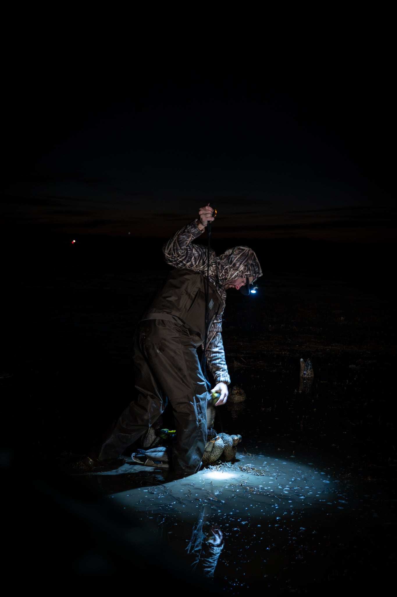 Night hunter in camo hat outdoors