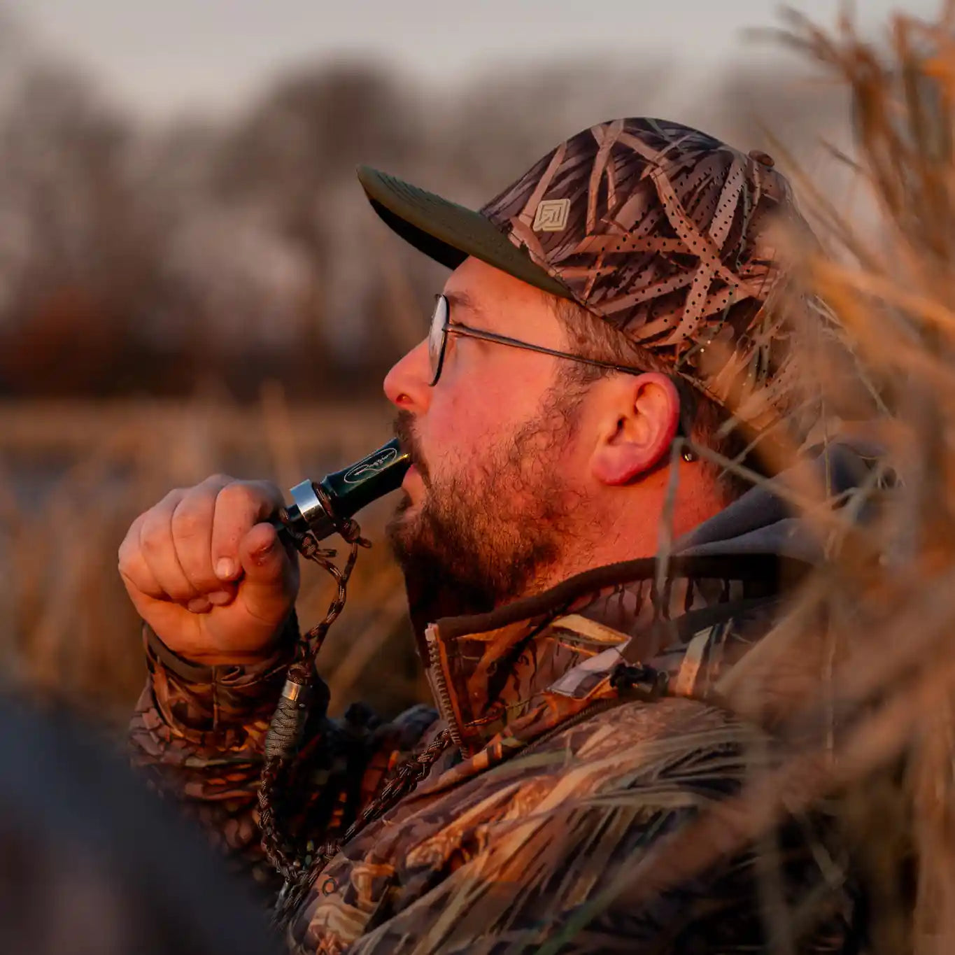 Hunter in camo hat blowing call