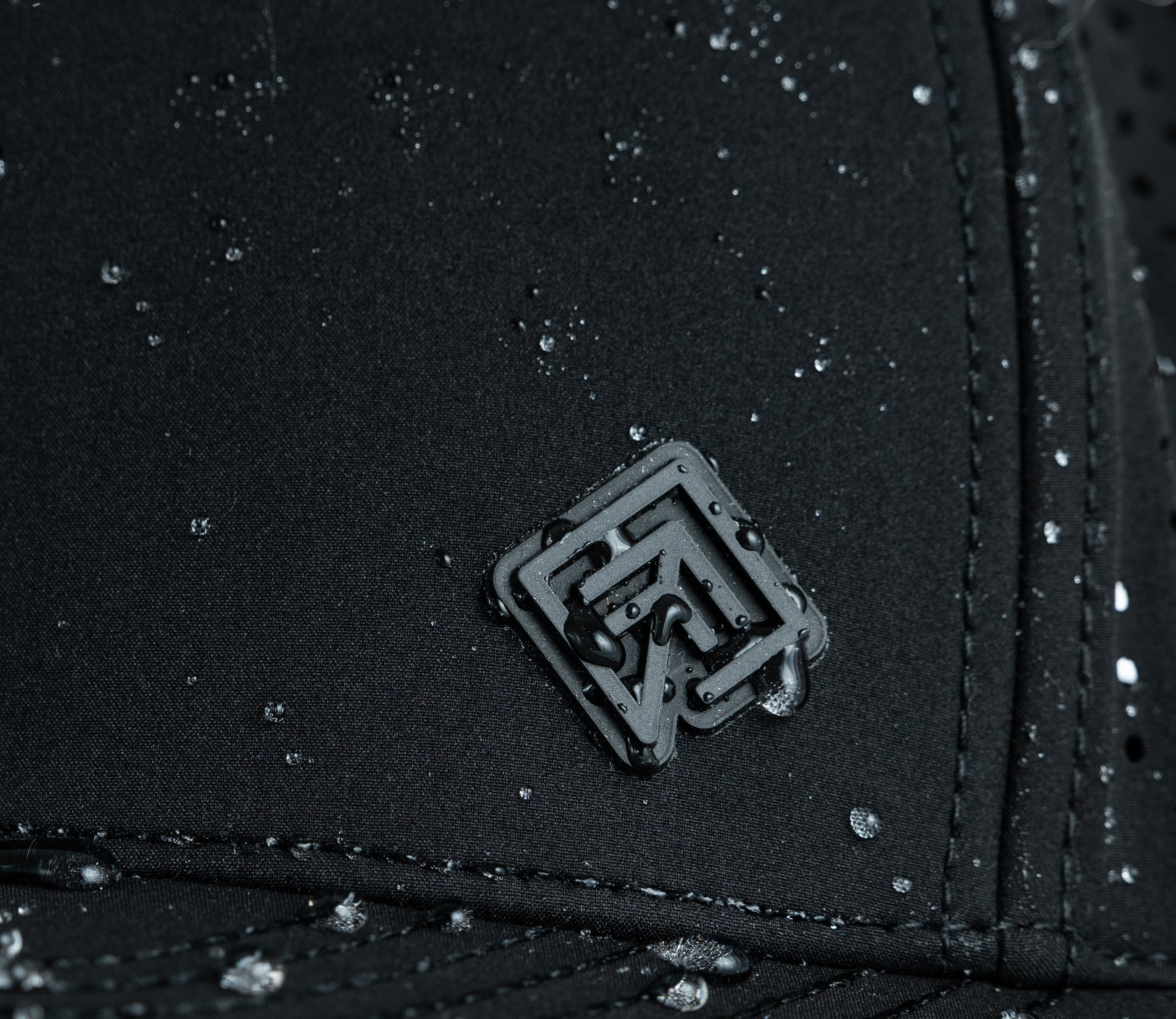 Water beading on black Terreno hat logo