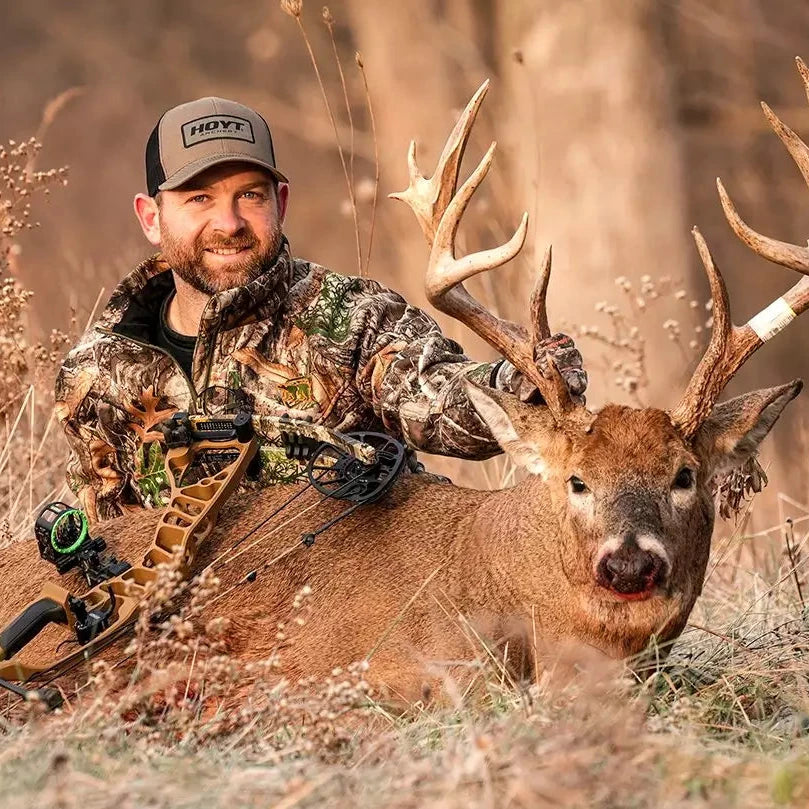 Hunter in hat with buck